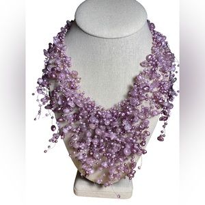 Invisible line lilac beaded necklace with gold tone extender.